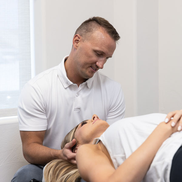 Chiropractor St George UT Scott Dodds Adjusting Patient Woman